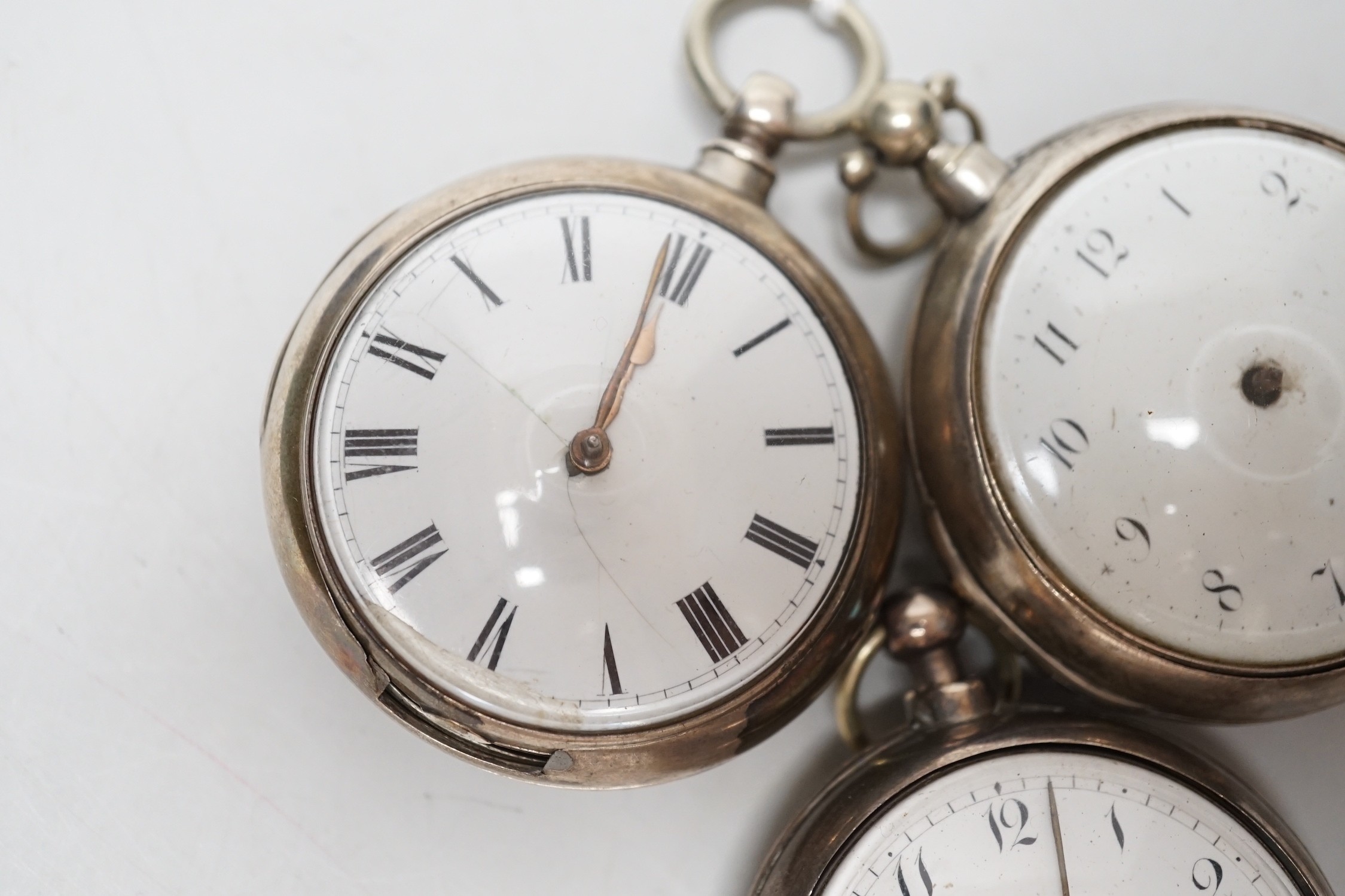 Three 19th century silver pair cased keywind verge pocket watches, by Graham, London, one signed WG, the other unsigned.